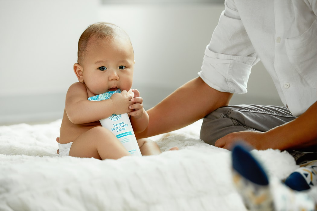 topless baby hugging white soft-tube
